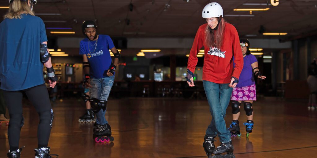 People roller skating in a rink.