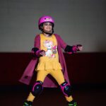 Young girl roller skating in a rink.