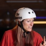 Woman in white helmet with "The Neutrino" logo.