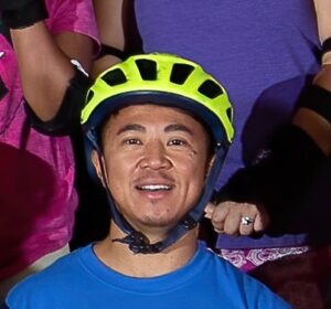 Man wearing a yellow helmet and blue shirt.