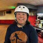 Woman in helmet at skate camp.