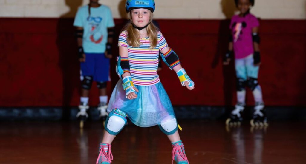 Girl roller skating in a rink.