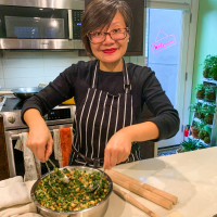 Woman prepares filling for dumplings.